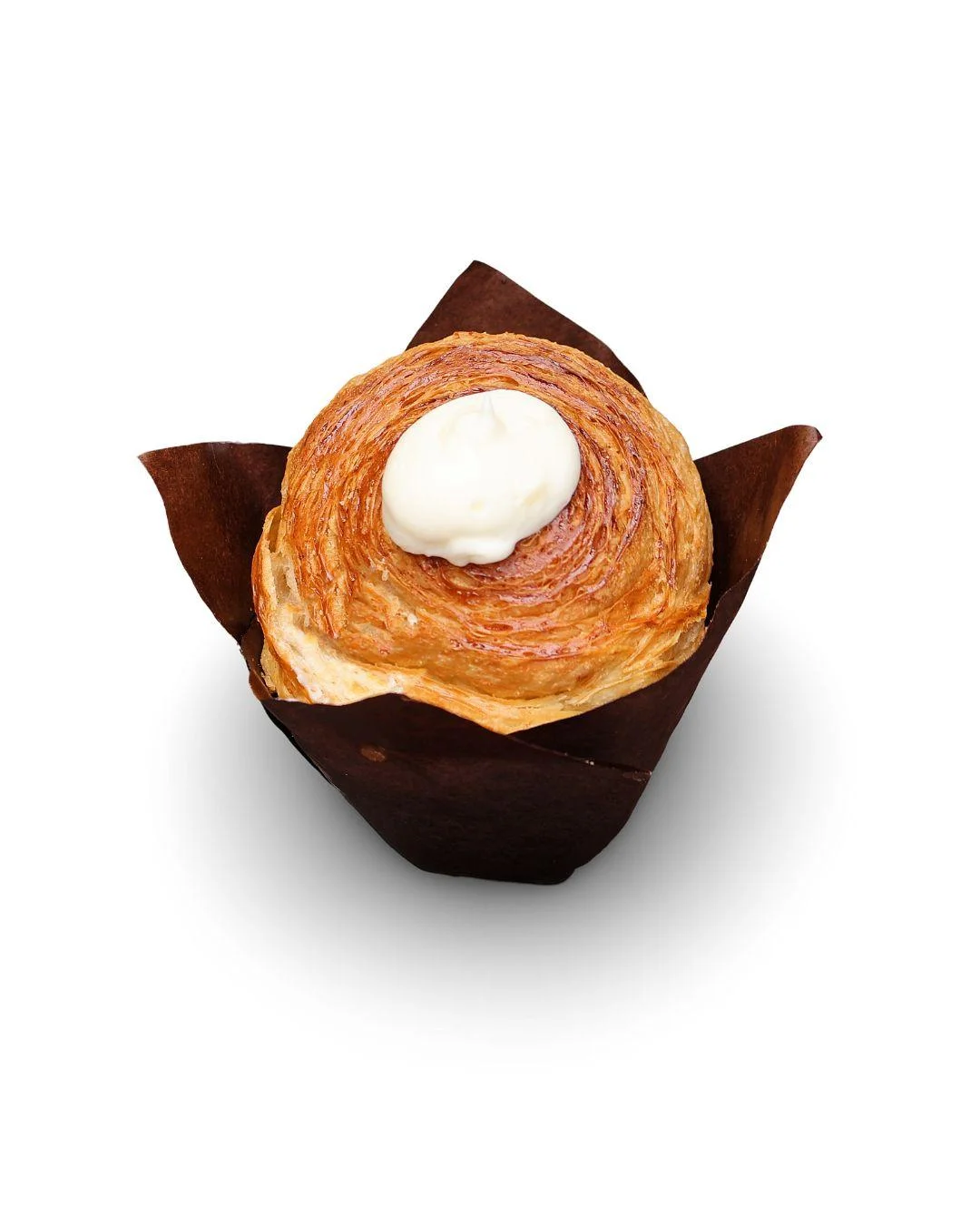 Round laminated pastry topped with cream on a white background